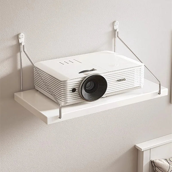 A white wall-mounted projector stand with a lens is displayed on a floating shelf.