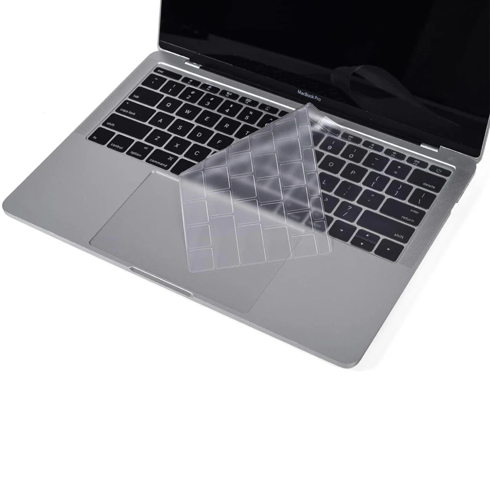 A clear TPU keyboard cover is placed on a silver MacBook laptop.