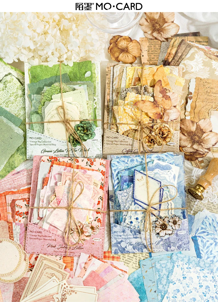 A collection of vintage paper cards and crafting materials including floral elements, for a MO-CARD kit.
