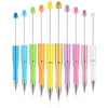 A collection of colorful plastic beaded ballpoint pens in various colors like blue, green, orange, yellow, and pink.