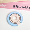 A light blue magnetic phone grip and stand with a foldable ring shown on a white surface.