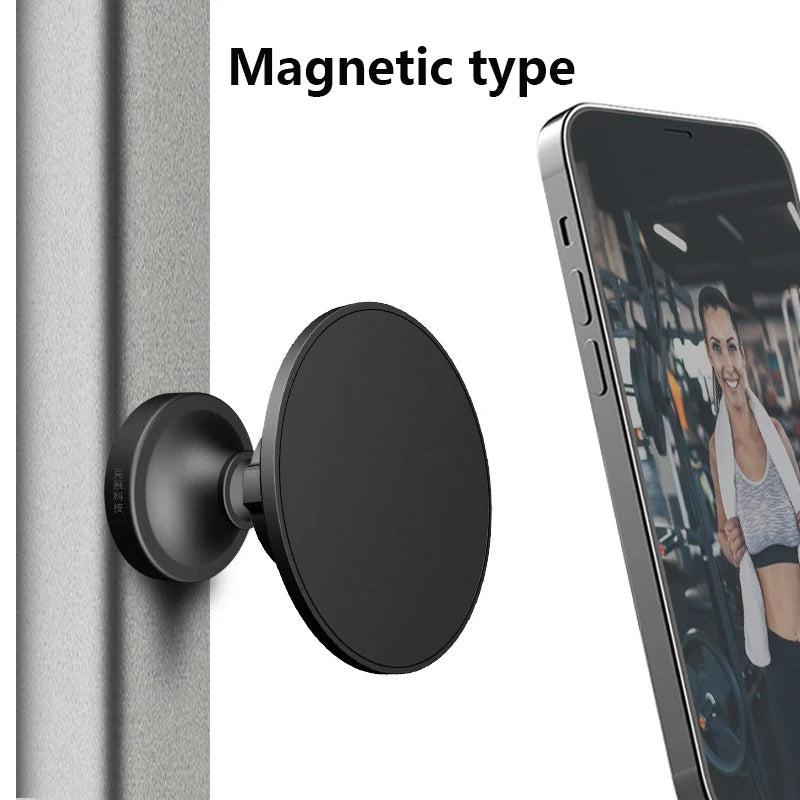 A black magnetic phone holder is shown mounted on a wall, next to an iPhone displaying a fitness video.