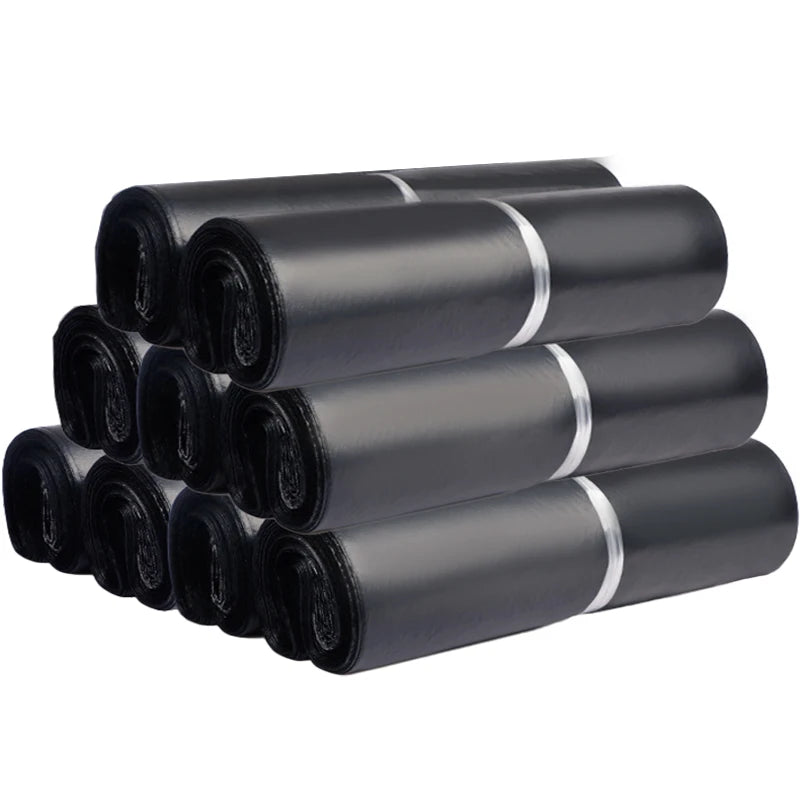 A stack of black poly mailers or self-sealing shipping bags.