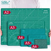 A collection of SiRo cutting mats labeled A2 through A6 with grid guides displayed on a green surface.