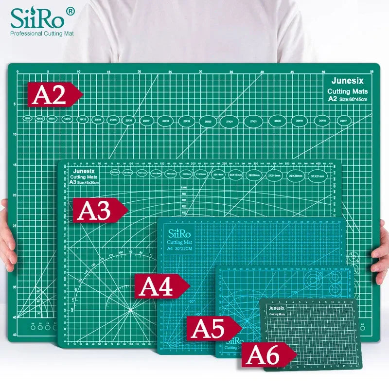 A collection of SiRo cutting mats labeled A2 through A6 with grid guides displayed on a green surface.