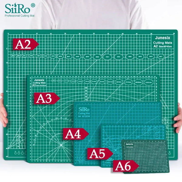 A collection of SiRo cutting mats labeled A2 through A6 with grid guides displayed on a green surface.