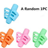 A random silicone pencil grip set featuring orange, pink, and green grips.