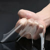A hand is applying clear, flexible double-sided nano adhesive tape to a surface.