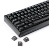 A close-up view of black carbon fiber texture keycaps for an MX Mechanical keyboard.