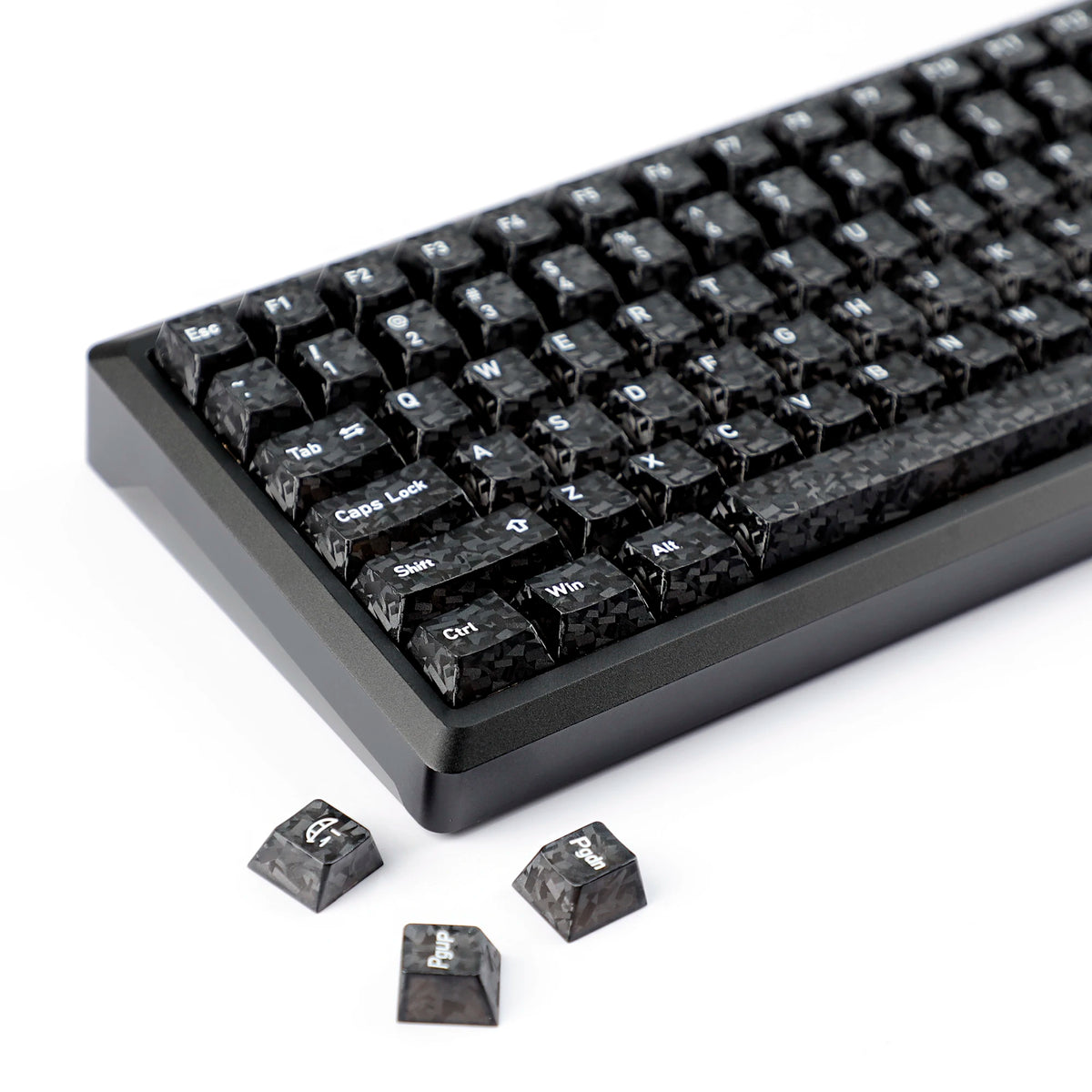 A close-up view of black carbon fiber texture keycaps for an MX Mechanical keyboard.