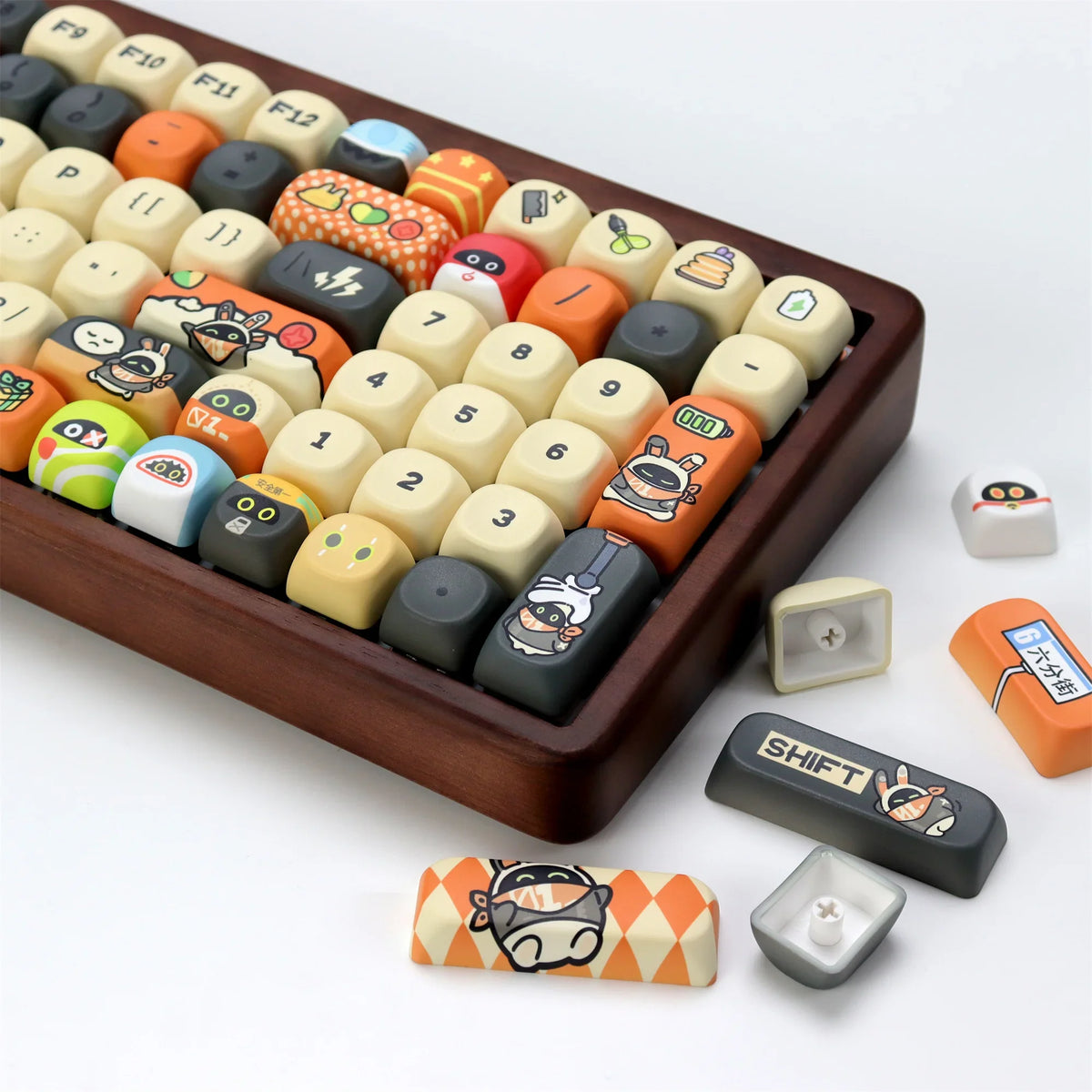 A brown tray holds various colored PBT keycaps for a mechanical keyboard, including orange, yellow, and white profiles.