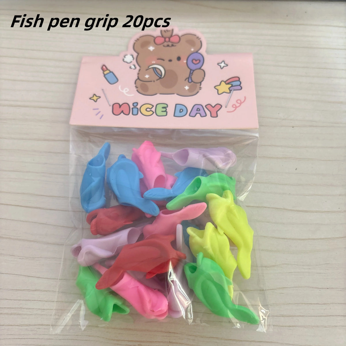 A clear plastic bag containing 20 pink and blue silicone fish pen grips with a cute bear design.