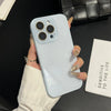 A hand holds a light blue iPhone case with a clear back, displaying the camera module and a gold nail polish.