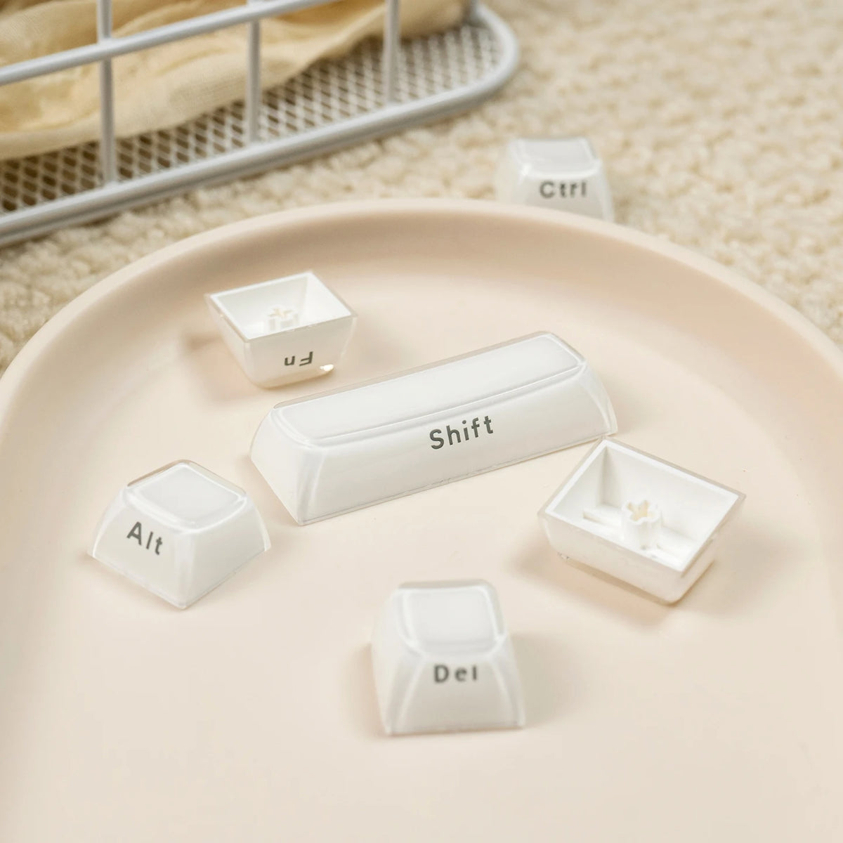 White custom printed jelly keycaps including Shift, Alt, Del, and Ctrl keys displayed on a light pink plate.