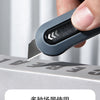 An orange and black Deli Mini Pocket Knife is shown in a close-up view.