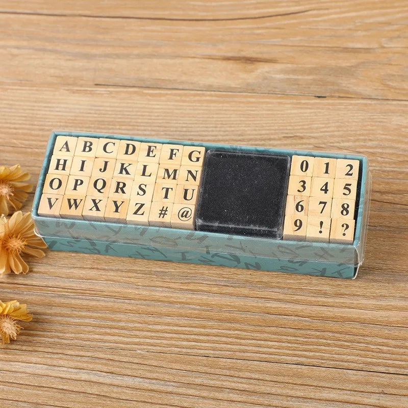 A rectangular wooden stamp seal set featuring letters, numbers, and symbols arranged in a grid on a light blue background.