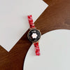 A close-up of a watch featuring a resin beaded watch band with a three-bead design and a round face.