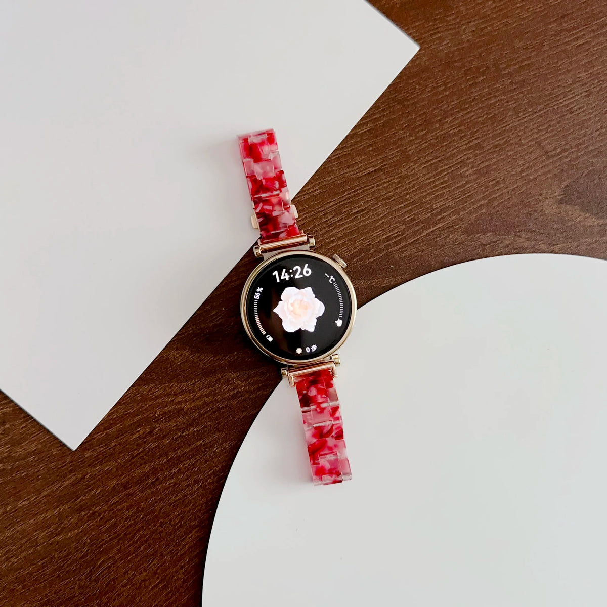 A close-up of a watch featuring a resin beaded watch band with a three-bead design and a round face.
