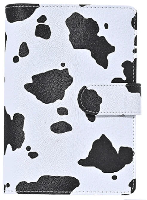 A white leather binder with a black leopard print pattern and a black elastic strap.