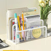A white metal mesh desk file organizer holding various stationery and planner pages.