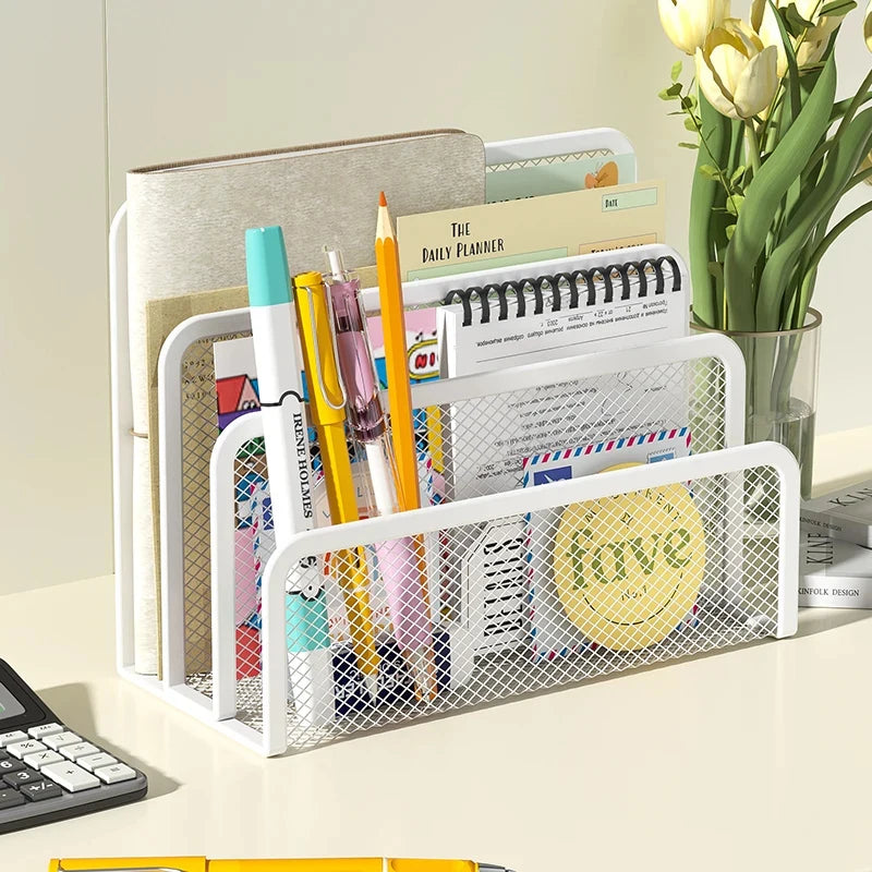 A white metal mesh desk file organizer holding various stationery and planner pages.