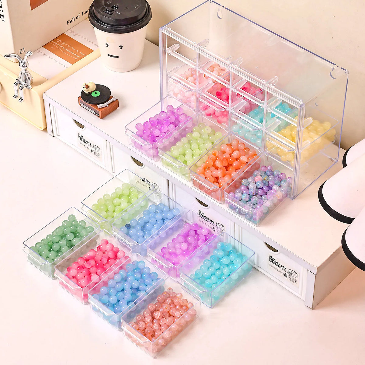 Acrylic transparent bead storage box with stackable compartments filled with various colored plastic beads