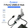 A silver USB 3.0 hub with seven ports and an aluminum alloy shell connected to a device.