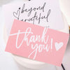Pink thank you card with black script saying beyond grateful