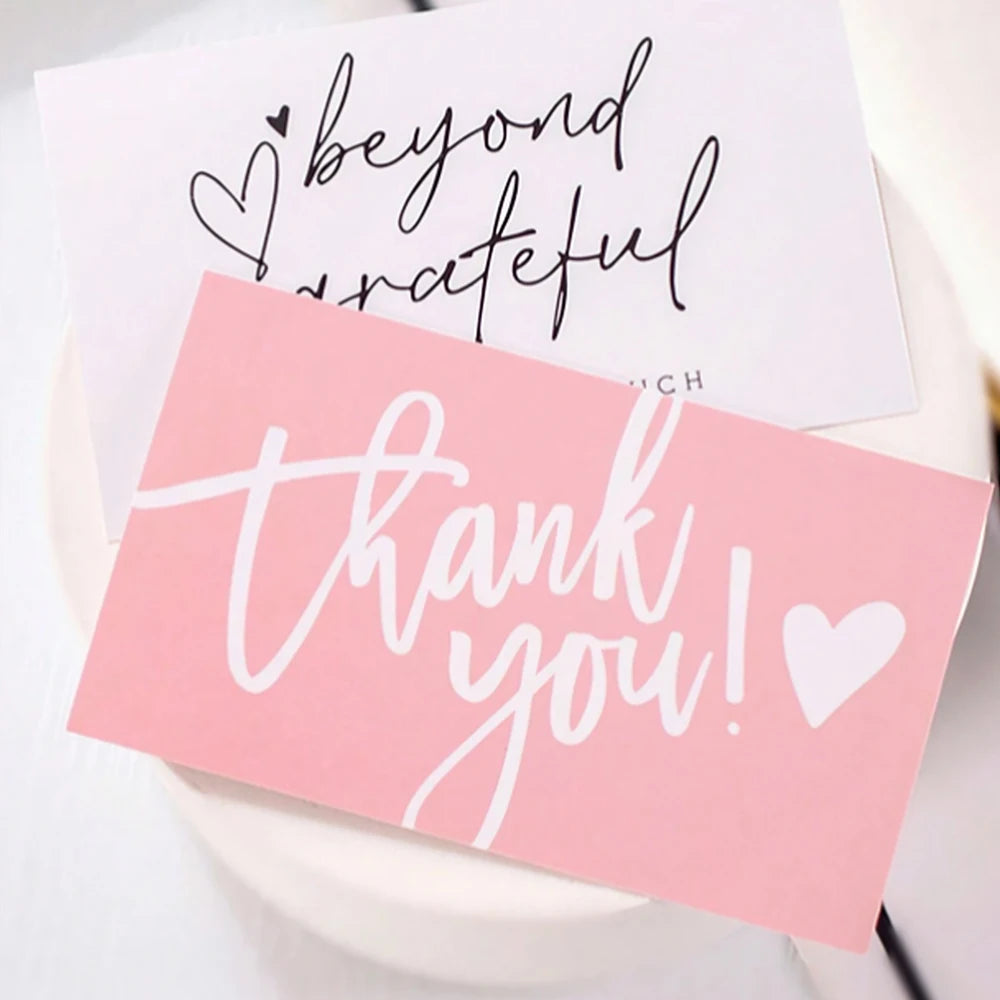 Pink thank you card with black script saying beyond grateful