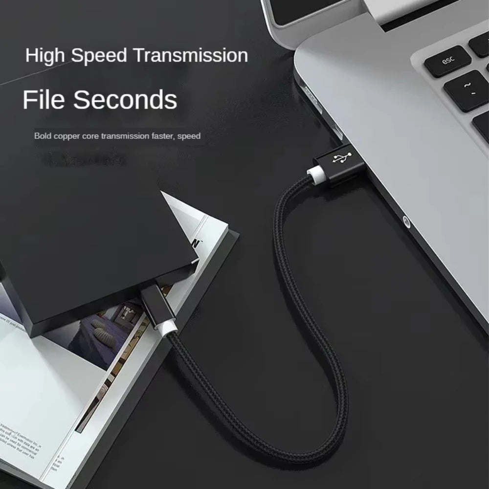 A black braided mini USB to USB cable is shown connected to a laptop, illustrating high-speed data transmission.