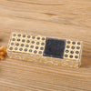 A wooden stamp seal set with alphabet and number stamps and a square stamp on a light brown background