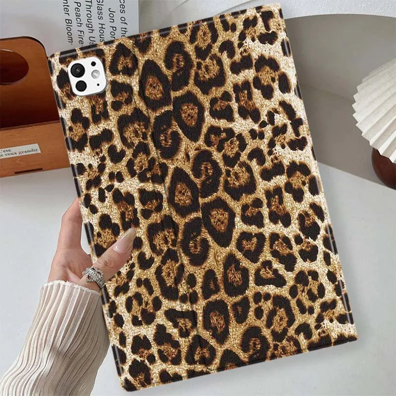 A close-up of a leopard print protective skin for an iPad case resting on a white surface.
