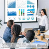 A woman points at a presentation screen displaying charts and graphs while sitting at a table.