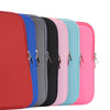 Una fila de fundas delgadas de laptop de algodón colorido en rojo, azul, gris, negro, rosa y azul claro.
