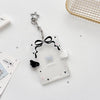 Clear acrylic card holder with a black bow and star charm attached to a silver keychain.