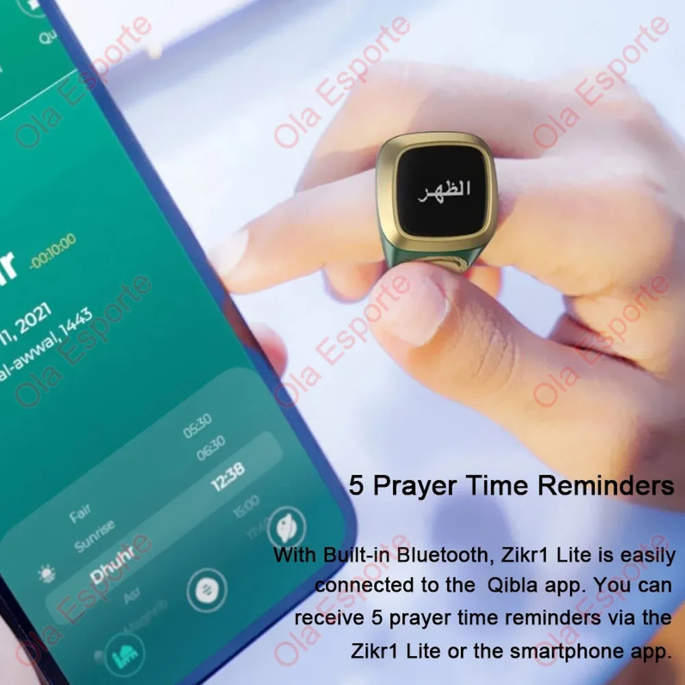 A hand holds a gold-colored digital Zikr ring, used for prayer time reminders.
