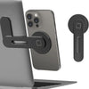 A magnetic phone holder is attached to a laptop, with a smartphone resting on the holder.