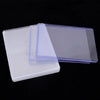 A stack of clear protective card sleeves with anti-scratch film, showing various thicknesses and angles.