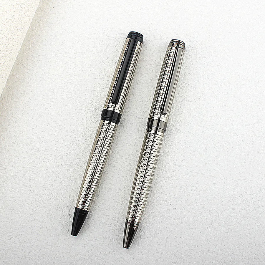 A silver and black premium metal ballpoint pen is shown diagonally on a white surface.