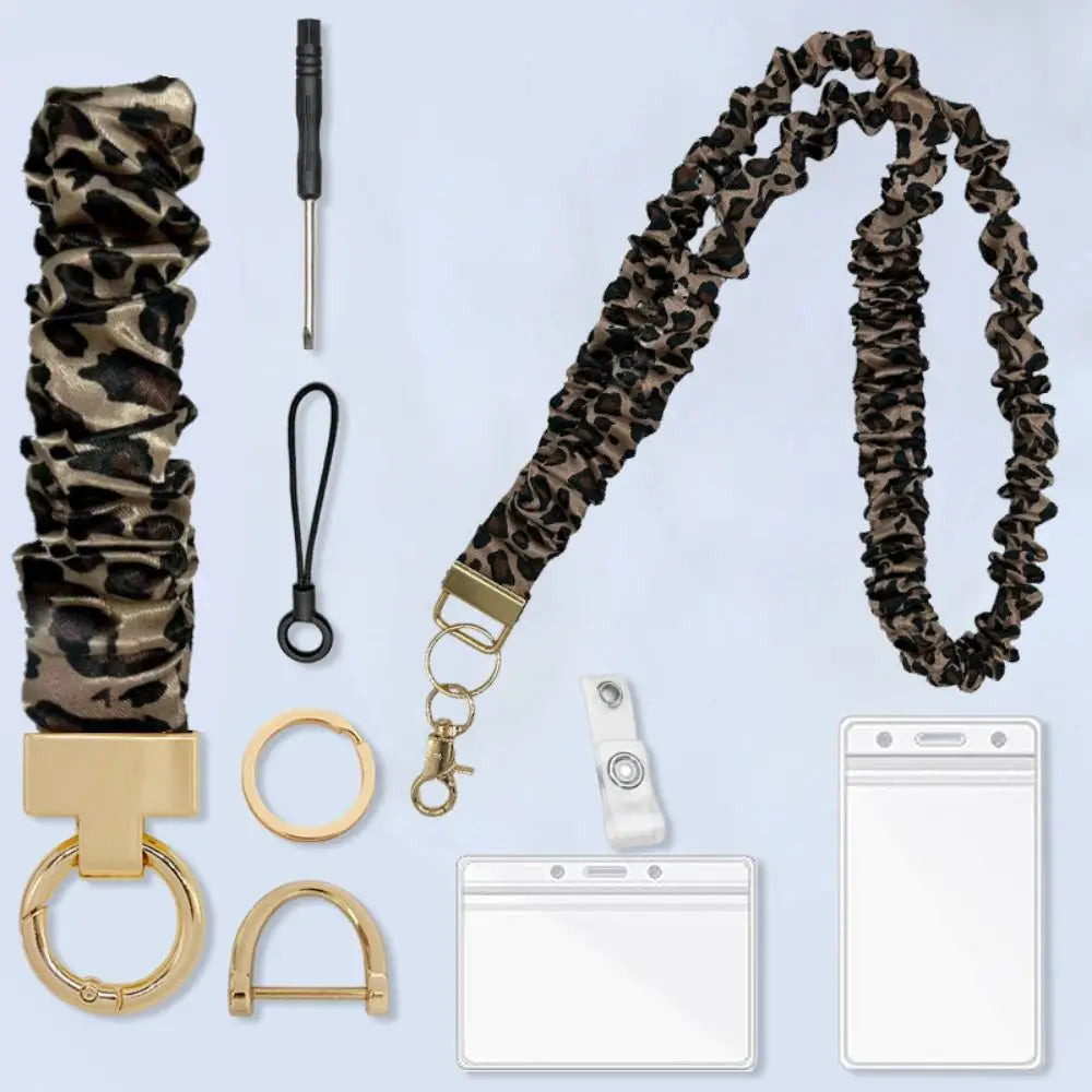 A stylish leopard print stretchy breakaway ID badge lanyard with a retractable reel and various hardware components.