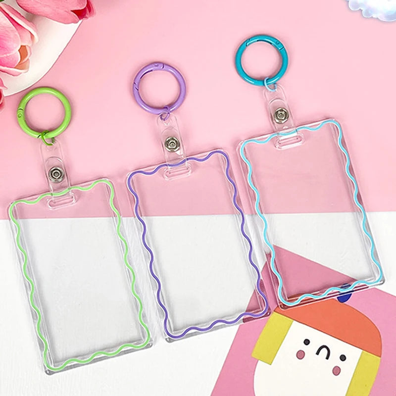 Clear acrylic card holder with a pink and white gradient design and colorful keychain rings