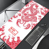 A red and white Japanese-style gaming desk mat featuring a dragon design placed on a dark surface.
