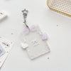 Clear acrylic card holder with a purple ribbon and small decorative elements, attached to a silver keychain.