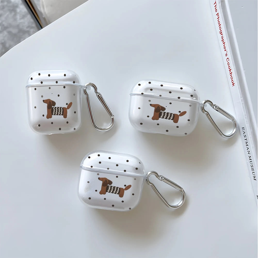 Three clear silicone TPU cases decorated with a brown and black dachshund pattern resting on a white surface.