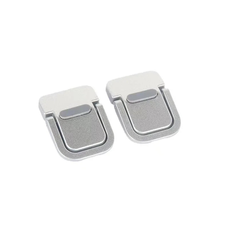 A pair of silver foldable laptop stand risers or grips.