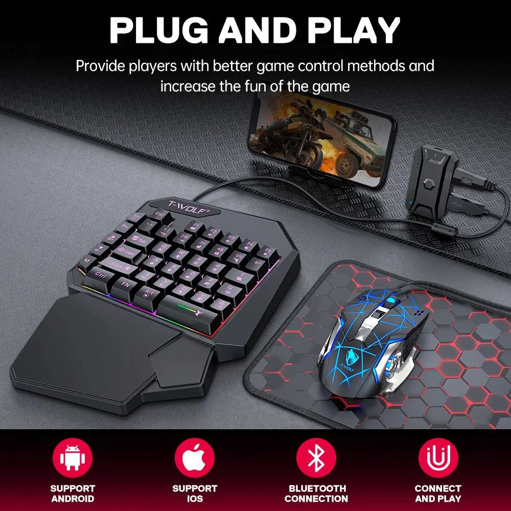 A black T-Wolf plug and play mobile gaming keyboard and mouse combo with a charging cable and a hexagonal mousepad.