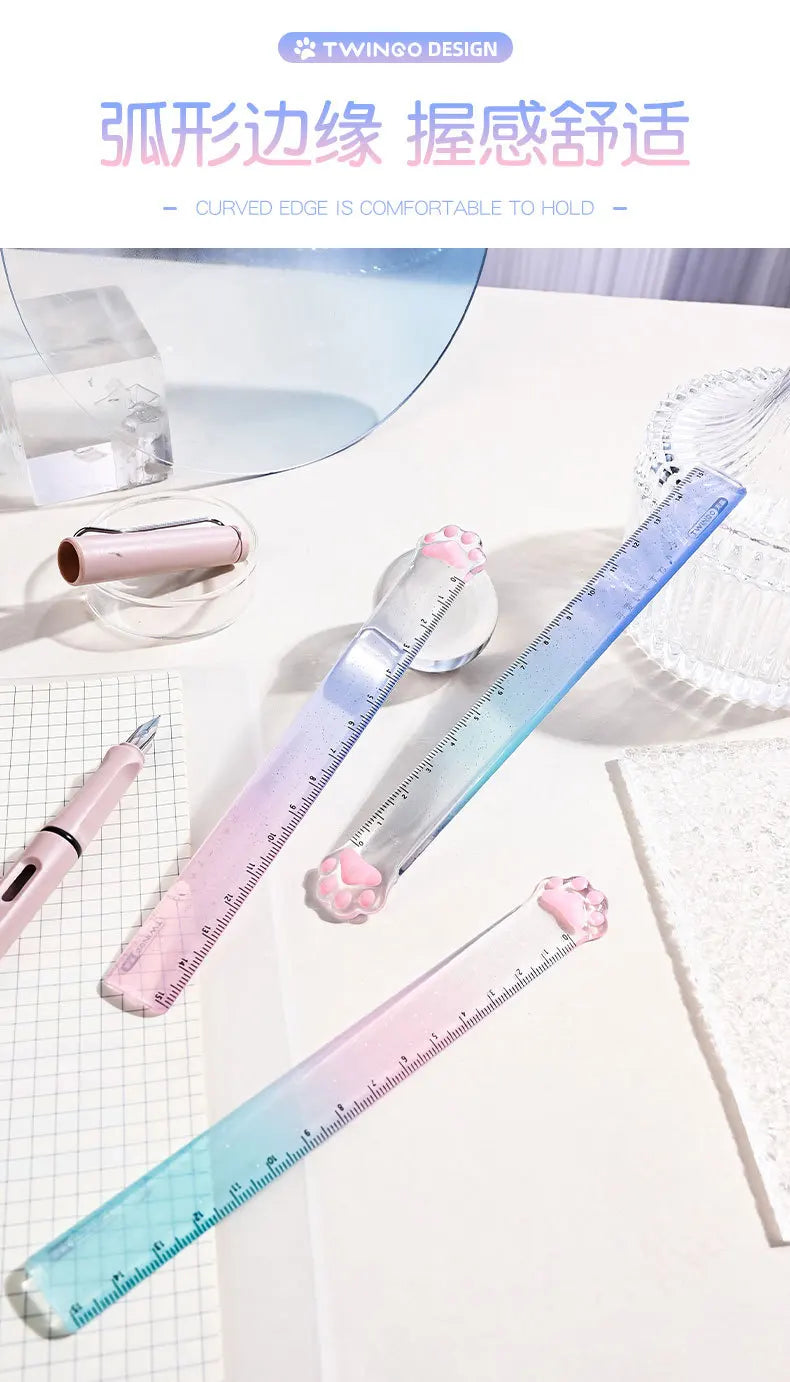 A set of pink and blue gradient measuring rulers featuring cute cat paw shaped edges on a white surface.