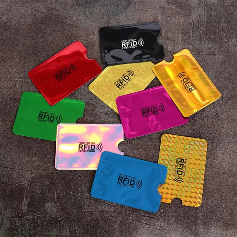 Five colored anti-theft aluminum card holders displayed on a dark surface.
