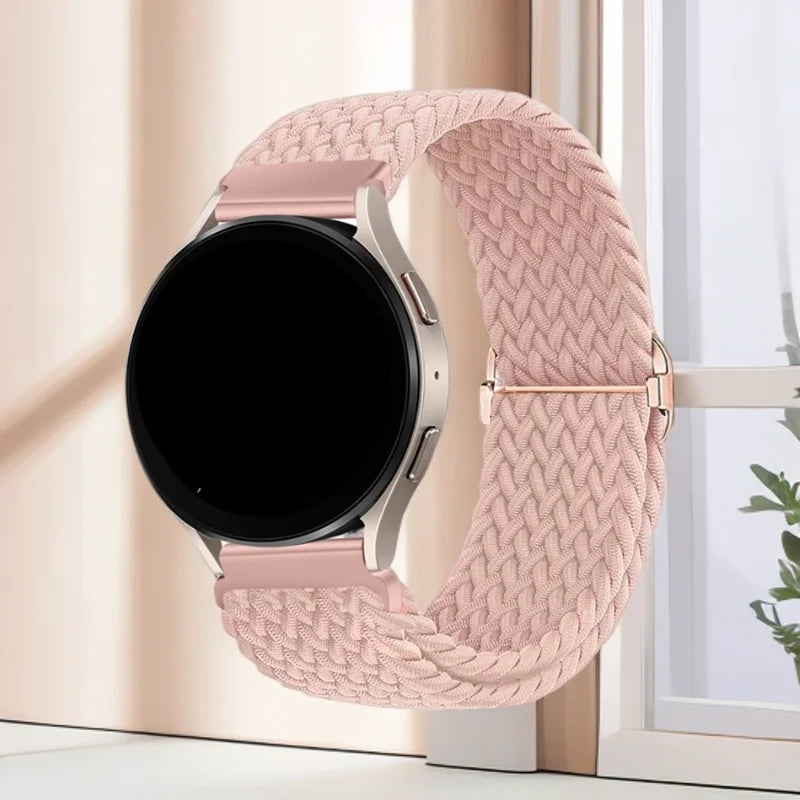 A pink knitted nylon watch strap is displayed next to a black smartwatch face.