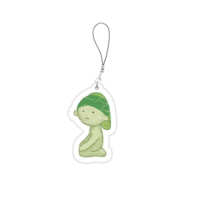 A green, face-like acrylic charm attached to a keyring.